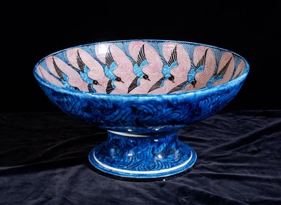 Deep punch bowl, with two eagles in the centre surrounded by swallows by William de Morgan